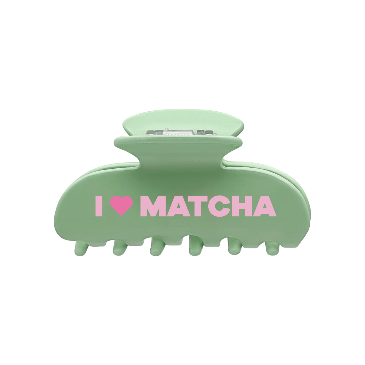 Front view of a green claw clip with the words “I”, a pink heart-shaped icon, and “MATCHA” printed across the front on a white background.