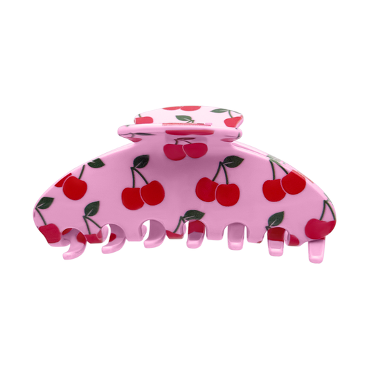 Front view of a pink claw clip with an all-over red cherry and green leaf design.