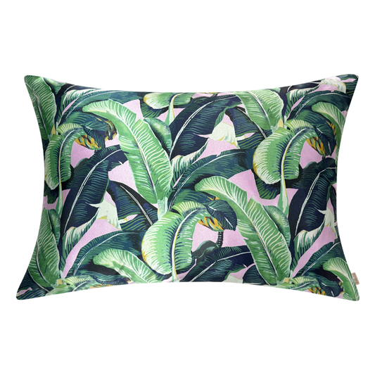 Satin pillowcase with green banana leaf print on a pink background, shown on a white background.