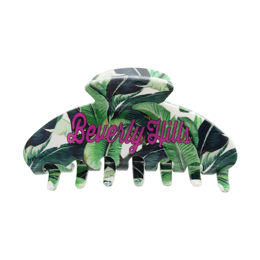Front view of a claw clip with a green banana-leaf pattern and pink “Beverly Hills” text on a white background.