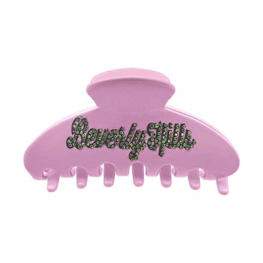Pink claw clip with green rhinestone “Beverly Hills” lettering on the front.