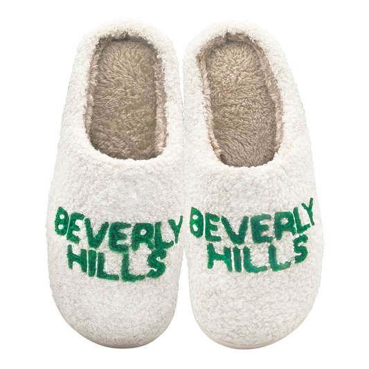 Pair of plush slippers with green “Beverly Hills” text design on the front.