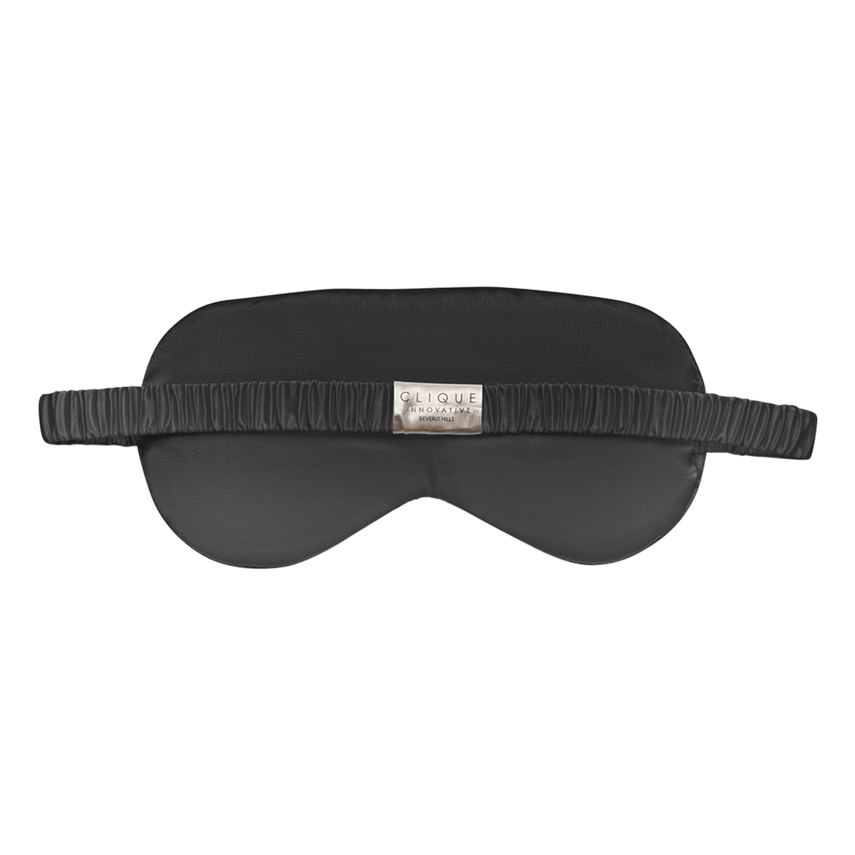 Back view of a black satin sleep eye mask with a ruched elastic strap and a small Clique Innovative Beverly Hills label, shown on a white background.
