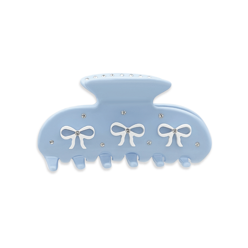 Front view of a light blue claw clip with three white bow graphics and silver rhinestones on a white background.
