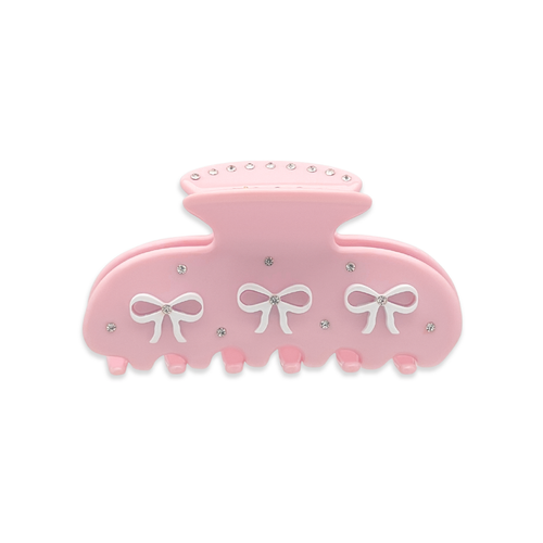 Front view of a light pink claw clip with three white bow graphics and silver rhinestones on a white background.