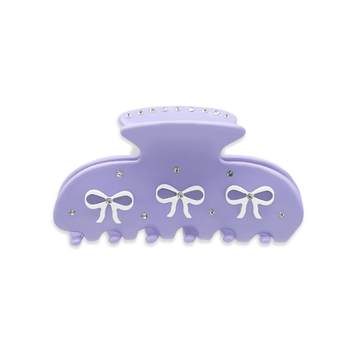 Front view of a light purple claw clip with three white bow graphics and silver rhinestones on a white background.