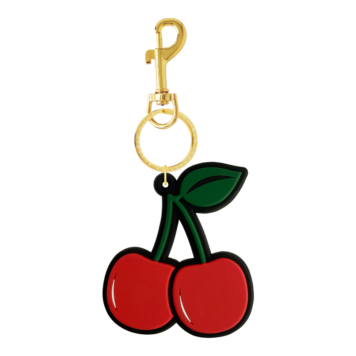 Cherry-shaped bag charm with a gold keyring engraved with “Clique Innovative Beverly Hills,” shown on a white background.