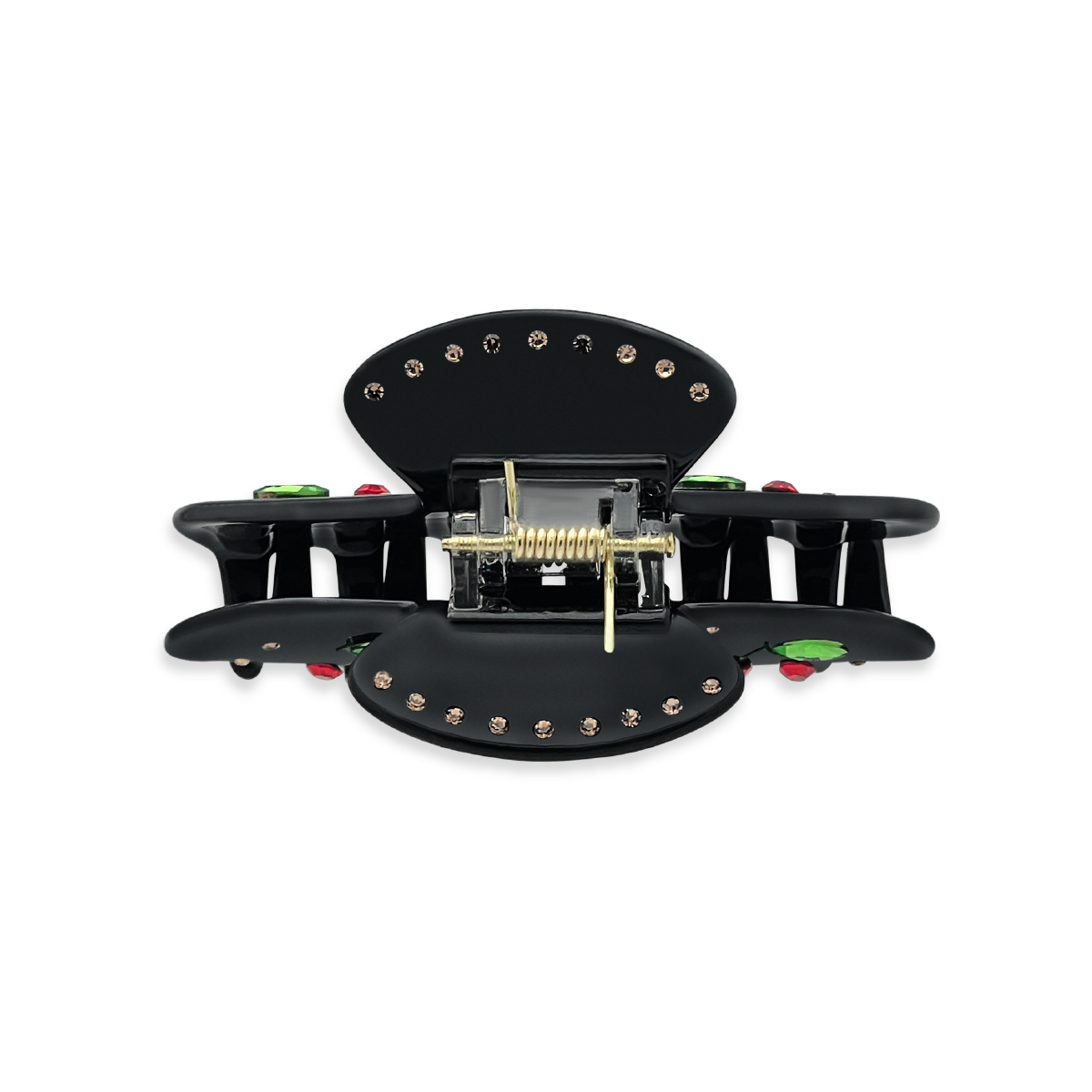 Top view of a black claw clip showing gold rhinestones along the top edges, a gold spring mechanism, and glimpses of green leaf rhinestones and red cherry details on a white background.