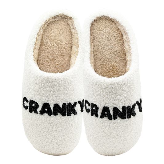 White fuzzy slippers with black CRANKY text