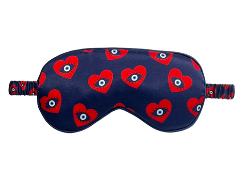 Front view of a navy satin eye mask with red evil eye heart motifs.