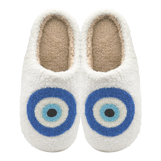 Pair of white slippers with blue evil eye design on a white background