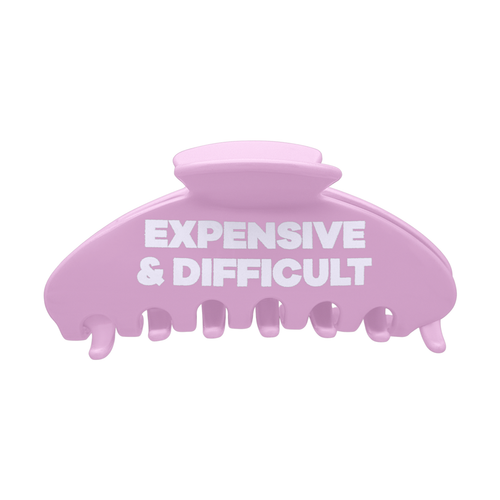 Front view of a pink claw clip with white Expensive & Difficult text