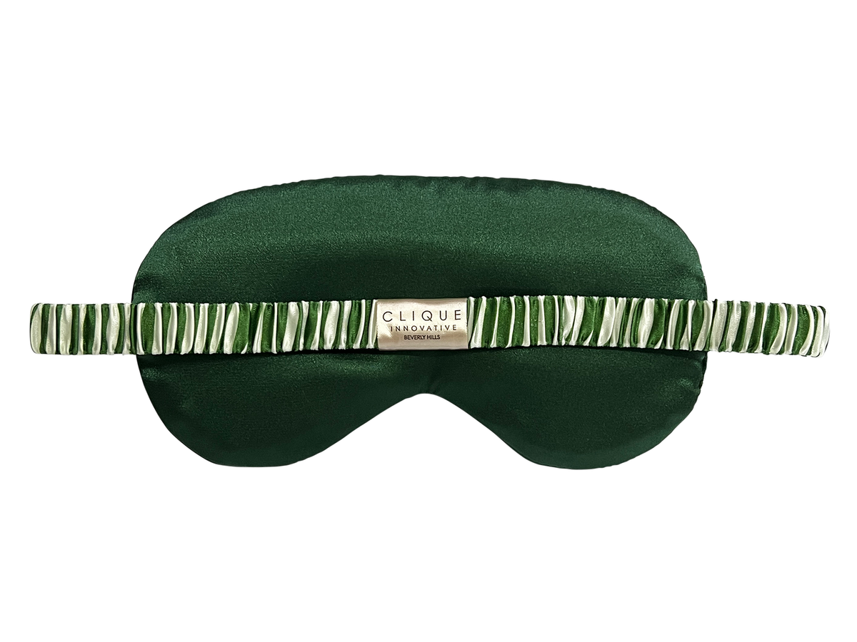 Back view of the green and white striped satin eye mask showing the elastic strap.