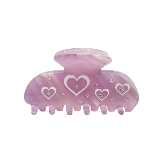 Front view of a blush mauve claw clip with multiple white heart-shaped graphics and small silver rhinestone accents on a white background.