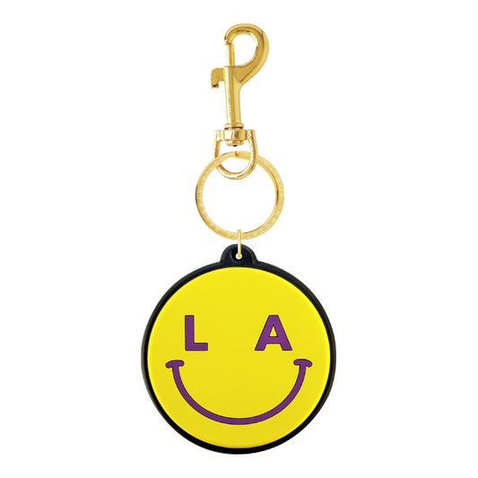 Yellow LA smiley bag charm with purple details and gold-tone hardware