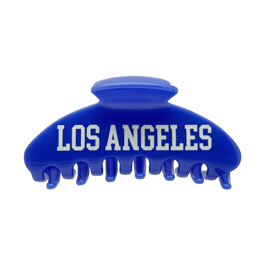 Front view of a blue claw clip with bold white Los Angeles block lettering.