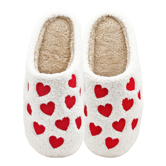 White fuzzy slippers with embroidered red hearts