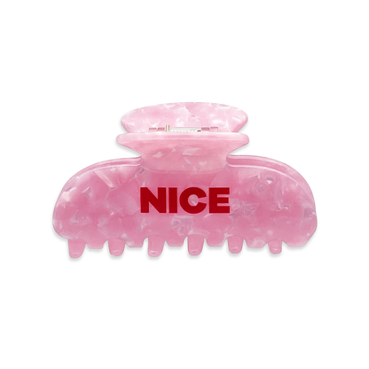 Back view of a pink marble claw clip with bold red “NICE” text on the front.