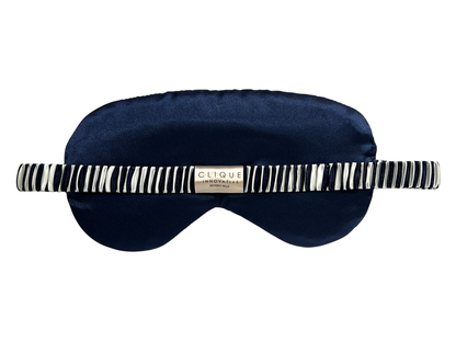 Back view of the navy blue and white striped satin eye mask showing the elastic strap.