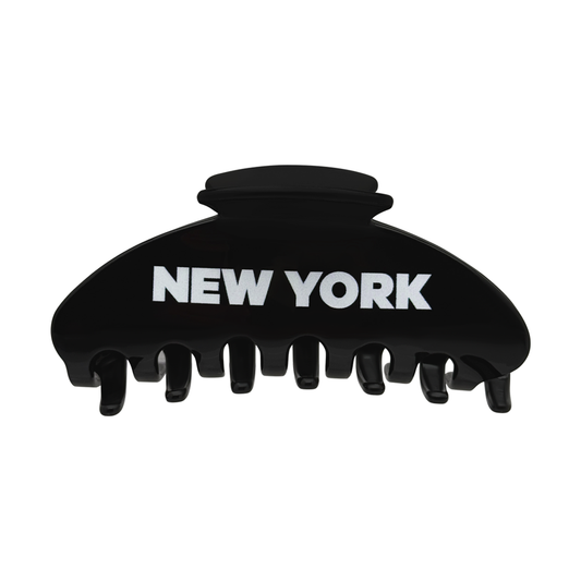 Front view of a black claw clip with bold white New York lettering.