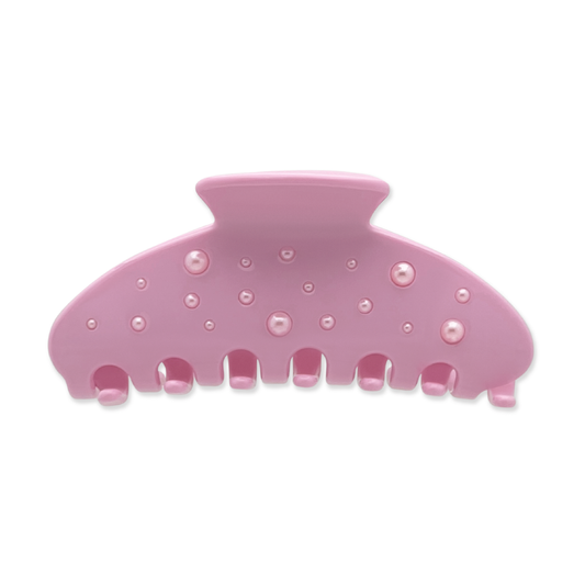 Front view of a pink claw clip with scattered faux-pearl accents on a white background.