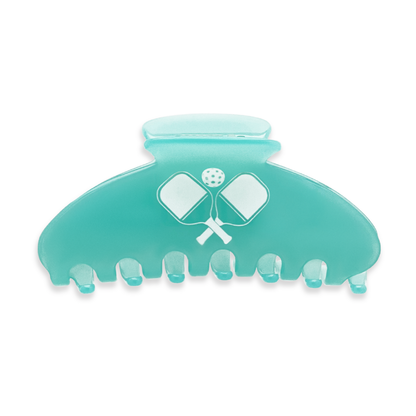 Back view of a teal claw clip with crossed pickleball paddles and a pickleball design on a white background.