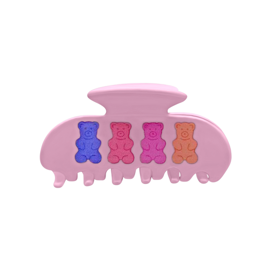 Front view of a pink claw clip with four colorful gummy bear designs on a white background.