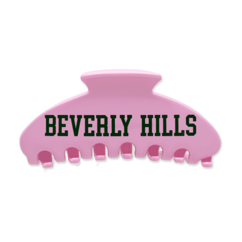 Pink claw hair clip with green “Beverly Hills” lettering on the front.