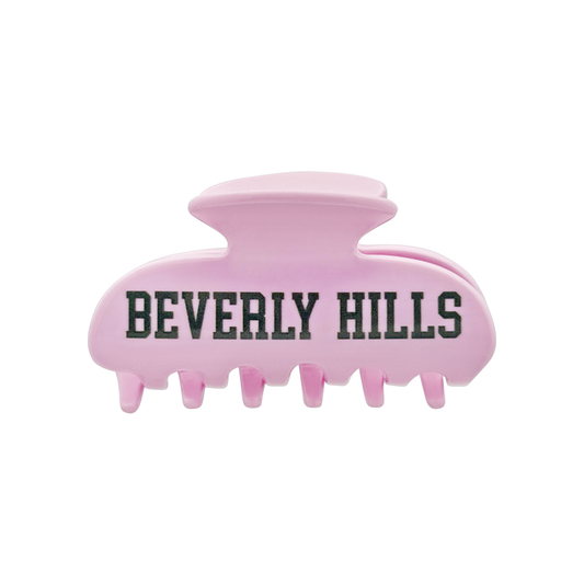 Pink claw hair clip with green “Beverly Hills” lettering on the front.