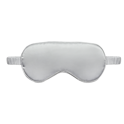 Front view  of a light silver satin sleep eye mask with an elastic ruched strap, shown on a white background.