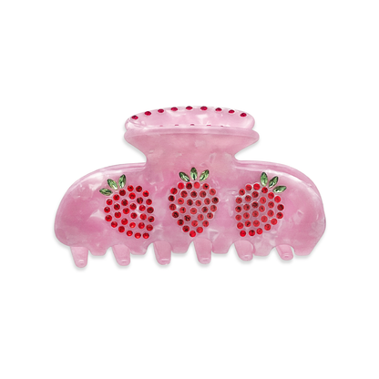 Front view of a pink marble claw clip with red and green rhinestone strawberry design on a white background.