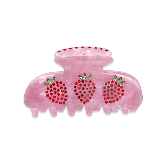 Front view of a pink marble claw clip with red and green rhinestone strawberry design on a white background.