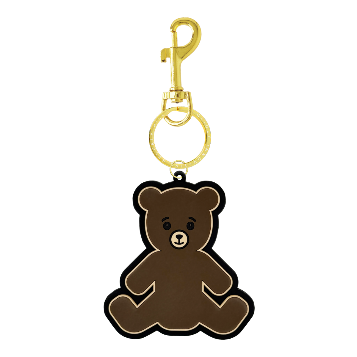 Brown teddy bear bag charm with a gold clasp and a gold split ring engraved with ‘Clique Innovative Beverly Hills,’ shown on a white background.