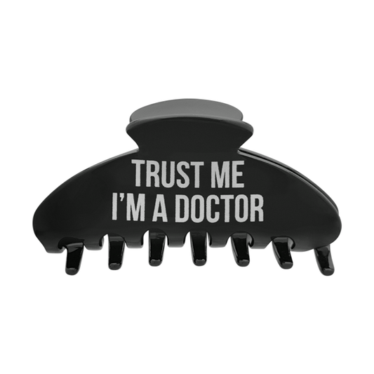 Front view of a black claw clip with “Trust Me I’m a Doctor” printed in white text.